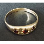 A 9ct gold ring set with 3 garnets.