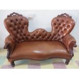 A brown leather carved two seater sofa
