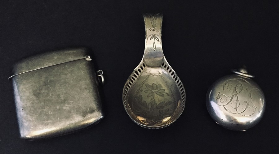 A hallmarked silver vesta along with a silver caddy spoon and silver sovereign case.