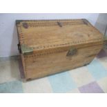 An antique pine trunk with brass studding