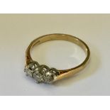 An 18ct gold ring with three good diamonds.