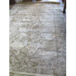 A beige ground man made silk carpet