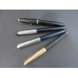 A collection of three Parker pens along with one other
