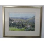 A watercolour of a landscape overlooking a town signed Joseph Zbukvic, 62.5cm x 78cm