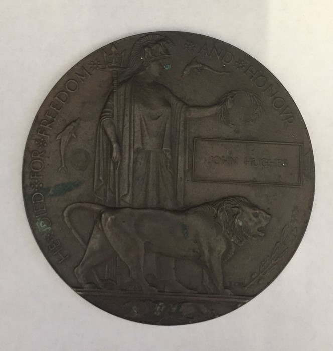 A WWI death plaque (penny) named to John Hughes.