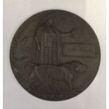 A WWI death plaque (penny) named to John Hughes.