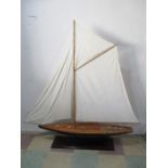 A model yacht on stand, believed to be modelled on an I class Americas cup yacht, 152cm height,