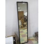 A full length mirror with painted wooden frame