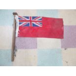 A vintage Red Ensign flag on wooden pole, 64 cm x 28 flag size