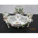 Four pieces of 19th century continental porcelain heavily encrusted with flowers, each piece