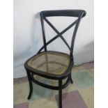 An ebonised cane seated bedroom chair
