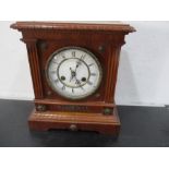 An oak cased mantle clock