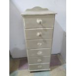 A narrow painted pine chest of six drawers