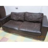A brown leather large two seater sofa