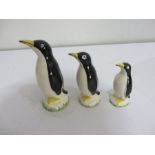 Three graduated penguin figures
