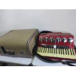A cased Parrot bass piano accordian