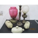 Two brass oil lamps ( cranberry shade A/F), brass lamp and three stoneware hot water bottles