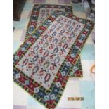 A pair of wool multi coloured rugs