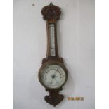 A carved oak barometer