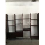 A four section ladderax dark wood modular shelving unit