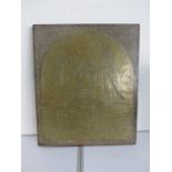 A brass wall hanging plaque