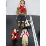 A bisque headed doll dressed in army sergeants uniform along with two small dolls dressed in
