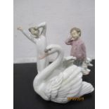 A Lladro swan along with a Lladro figure of a boy yawning and a Nao figure of a boy with teddy bear