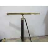 A brass telescope on tri-pod base