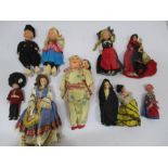 A Japanese figure of mother and child along with vintage dolls from around the world