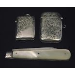 Two hallmarked silver vesta cases along with a silver bladed fruit knife.