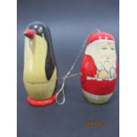 A vintage nesting father Christmas tree decoration along with a USSR nesting penguin with two babies