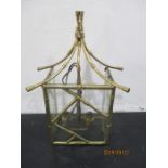 A modern wall light in the Chinese style with bamboo effect brass work