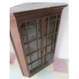 A Georgian oak glazed corner cupboard