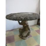 A concrete garden table on cherub base