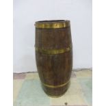 A brass bound wooden umbrella stand