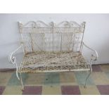 A wrought iron garden bench