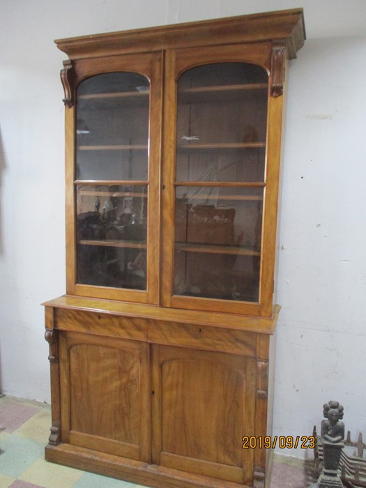 A tall Victorian display cabinet with cupboard under