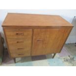 A mid century cabinet with integrated Singer sewing machine