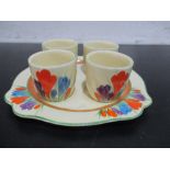 A set of four Clarice Cliff Crocus pattern egg cups on stand