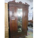 An Art Nouveau wardrobe with mirrored door