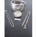 A hallmarked silver hinged bangle, silver locket, two bracelets and a pendant