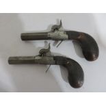 A pair of percussion cap pistols marked ELG one side and LP on the other