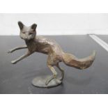 A metal sculpture of a prancing fox approx 13.5cm length