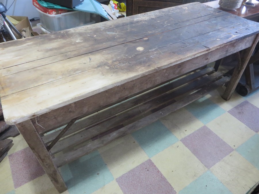 A vintage pine workbench/table with metal supports, approx 6 ft length