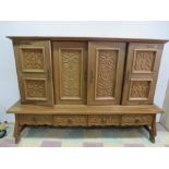 An carved oak sideboard on base with four drawers - key in office