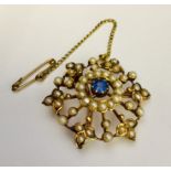 An unmarked gold brooch set with seed pearls, star shaped mark to reverse. Total weight 5.1g