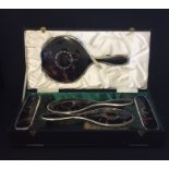 A cased hallmarked silver and tortoiseshell dressing table set- some A/F