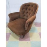 A Victorian button back armchair