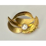 An 18ct gold brooch set with a pearl.