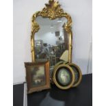 An ornate gilt mirror along with an oil painting and pair of oval prints of ladies